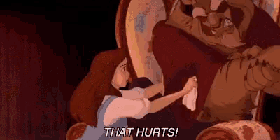 a woman is holding a piece of paper in front of a beast from beauty and the beast and says `` that hurts ! ''