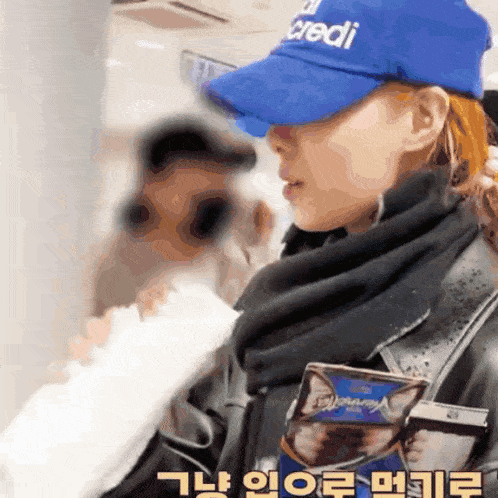 a woman wearing a blue hat that says " credi " on it