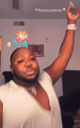 a man with a flower on his head and the hashtag @thesaucysantana on the bottom