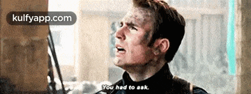 captain america from avengers : age of ultron is talking to a man with a gun .