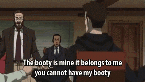 a group of men are sitting around a table and one of them is talking about the booty of another man .