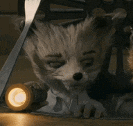 a fox is holding a flashlight and a pair of scissors .