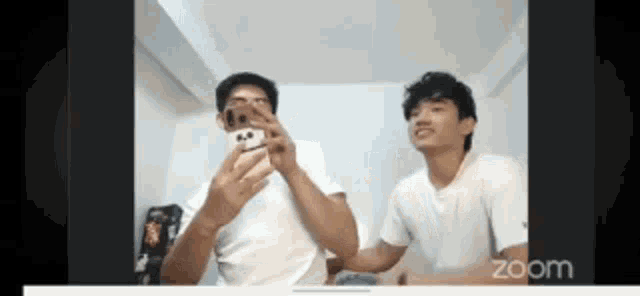 two men are taking a selfie on a video call .