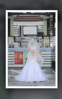 a woman in a wedding dress stands in front of a restaurant