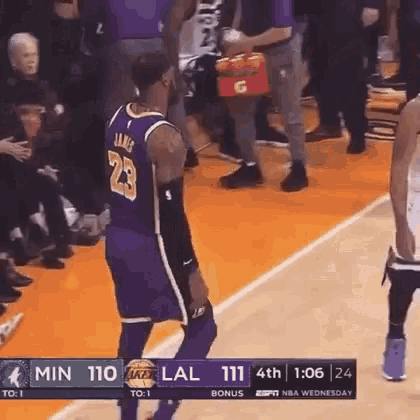 a basketball player with the number 23 on his jersey is standing on the court