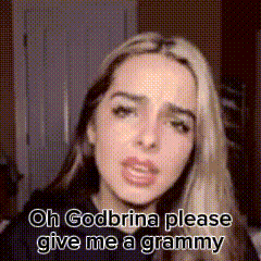 a woman is making a funny face and asking for a grammy .