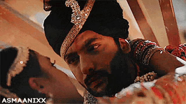 a man in a turban is kissing a woman on the forehead with the watermark asmaanixx