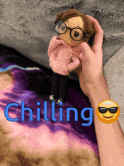 a person is holding a stuffed doll with the word chilling written on the bottom