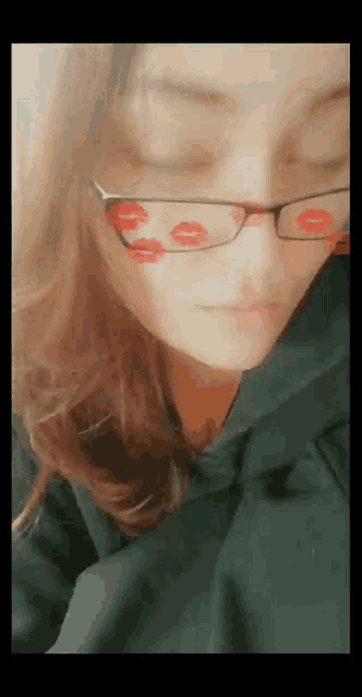 a close up of a woman wearing glasses with red kisses on them