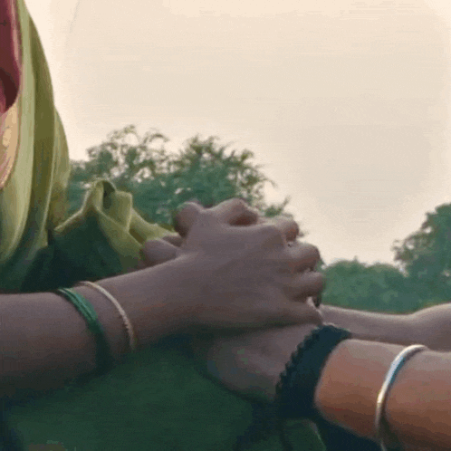 a close up of a person holding another person 's hands