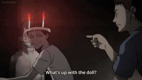a man pointing at a man with candles on his head and the words " what 's up with the doll "
