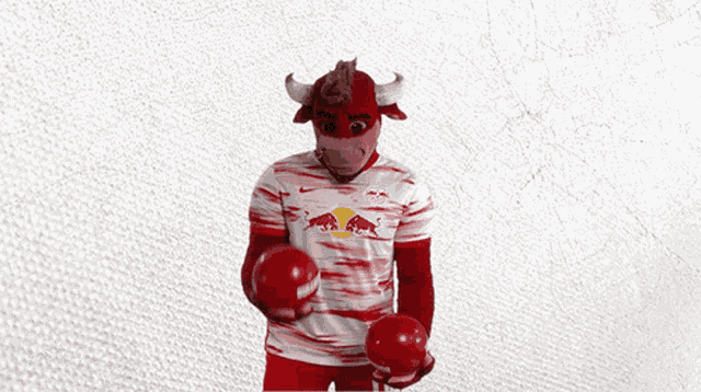 a man dressed as a bull holding a soccer ball