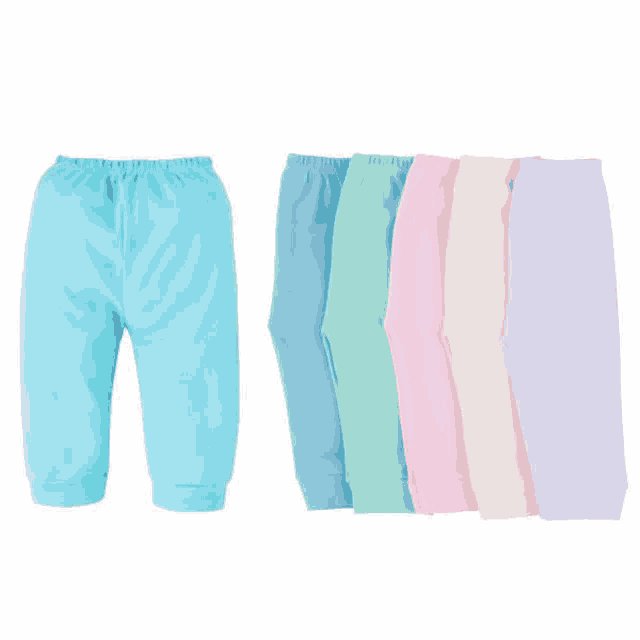 a row of baby pants in different colors are lined up in a row