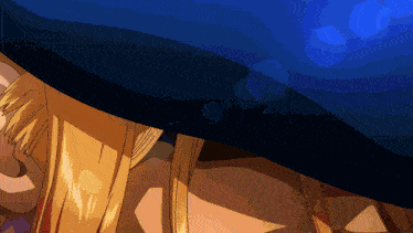a woman with blonde hair is laying under a blue curtain