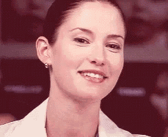 a close up of a woman 's face smiling