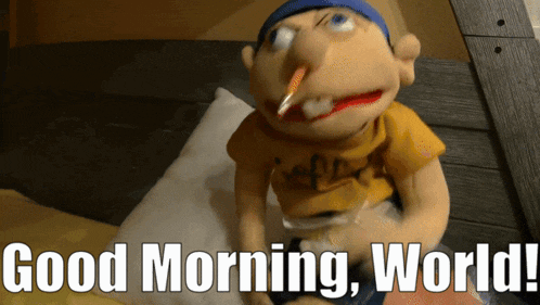 a puppet with a cigarette in his mouth is sitting on a bed and says " good morning world "