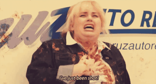 a woman is standing in front of a sign that says ' i 've just been shot ' on it