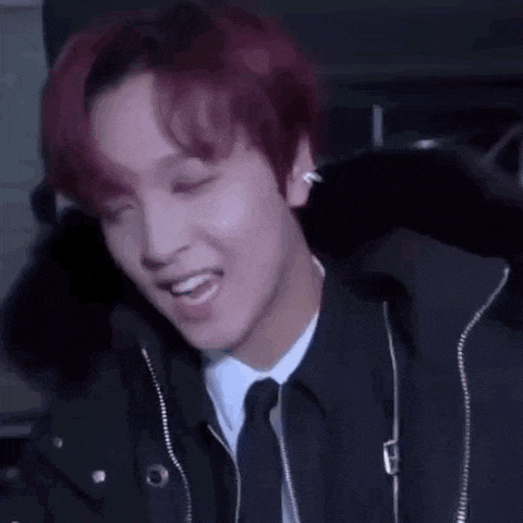 a close up of a person 's ear with red hair and a black jacket .