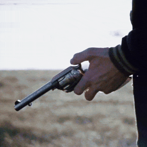 a person is holding a gun in their hand