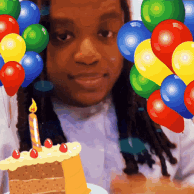 a woman with balloons and a birthday cake in front of her