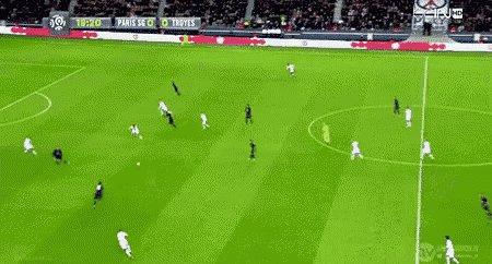 a soccer game is being played on a green field