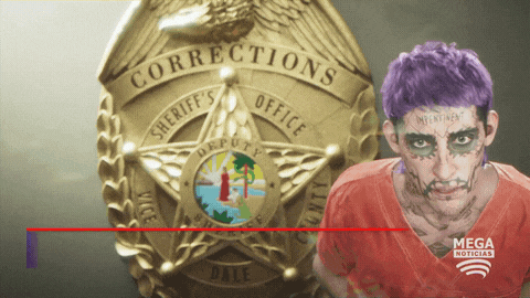 a man with purple hair stands in front of a corrections badge