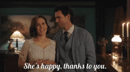 a man and a woman standing next to each other with the words she 's happy thanks to you