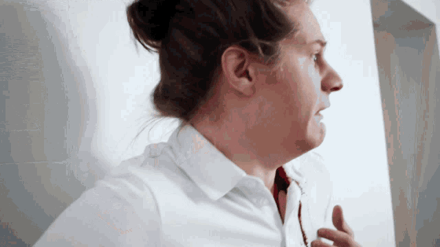 a woman wearing a white shirt and red tie