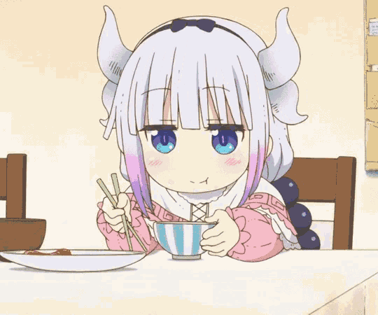 a cartoon girl with horns is sitting at a table eating food with chopsticks .