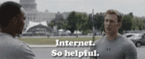 two men are standing next to each other in a park and talking about internet .