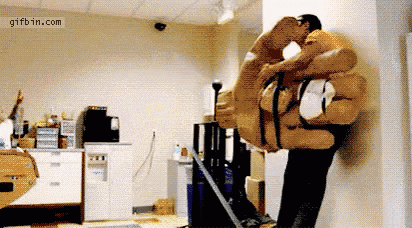 a man is carrying a giant peanut on his back ..