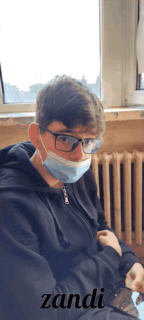 a young man wearing glasses and a face mask with the name zandi below him