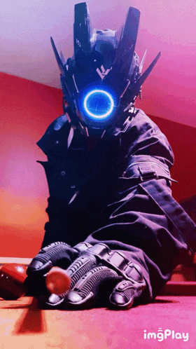 a person wearing a robot costume and gloves is sitting on a table with imgplay written below them