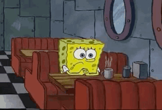 spongebob squarepants is sitting at a table in a diner holding a cup of coffee .