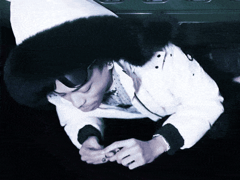 a person wearing a white jacket and a black fur hood
