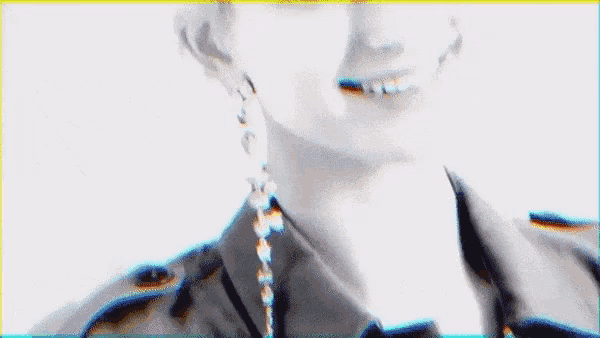 a close up of a woman wearing earrings and smiling