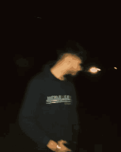 a blurry photo of a man wearing a hoodie that says jack & jones