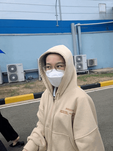 a person wearing a mask and a hoodie that says almost