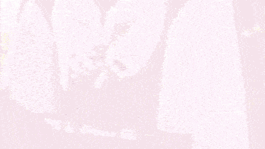 a woman in a pink dress holds a shopping bag