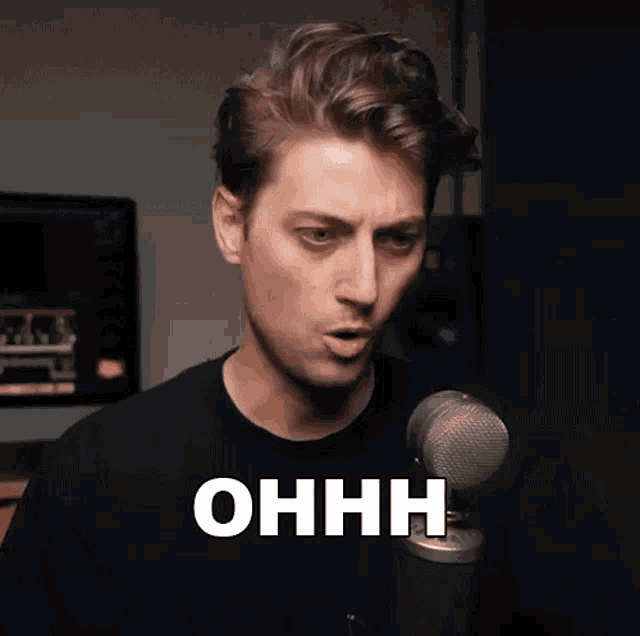 a man standing in front of a microphone with the word ohhh above his head
