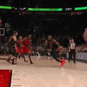 a basketball game is being played in a stadium with a green sign that says kobe bryant