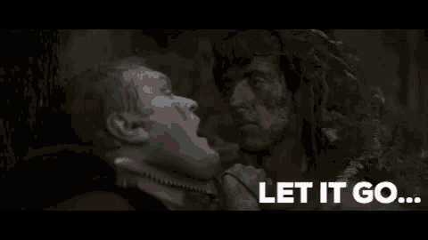 a man is holding a knife to another man 's neck in a movie .