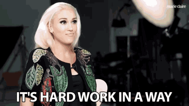 a woman says " it 's hard work in a way " in front of a camera