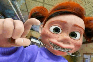 a cartoon girl with red hair and braces on her teeth is holding a pair of scissors .