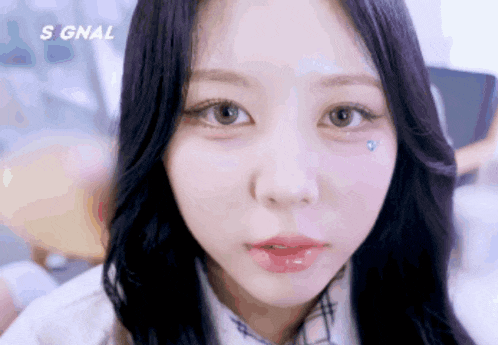 a close up of a girl 's face with the word signal above her head