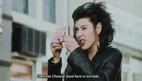 a woman is taking a picture of herself with a cell phone and says i bet the chinese food here is terrible