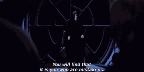 a man in a hooded jacket is standing in a dark room and talking to another man in a dark room .