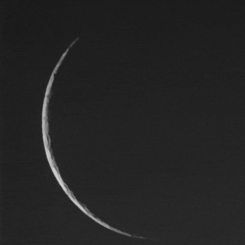 a black and white photo of the moon with a dark background