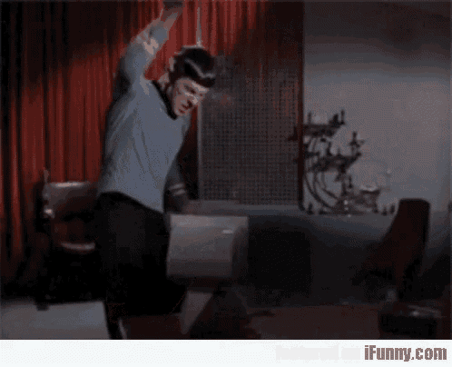 a man in a blue shirt is dancing in a room with ifunny.com written on the bottom right