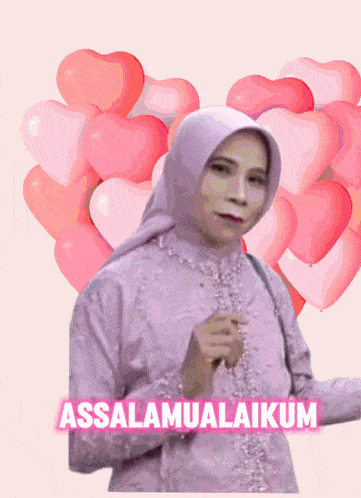 a woman is surrounded by pink heart shaped balloons and has a heart in front of her face that says assalamualaikum